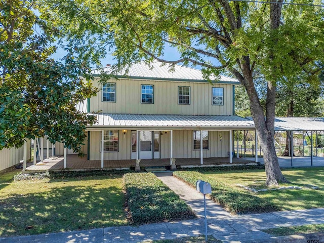 farmhouse-style home featuring covered porch and a front lawn