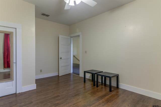 empty room featuring ceiling fan and dark wood-type flooring