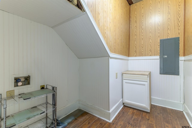 bonus room with electric panel, wooden walls, dark hardwood / wood-style flooring, and lofted ceiling