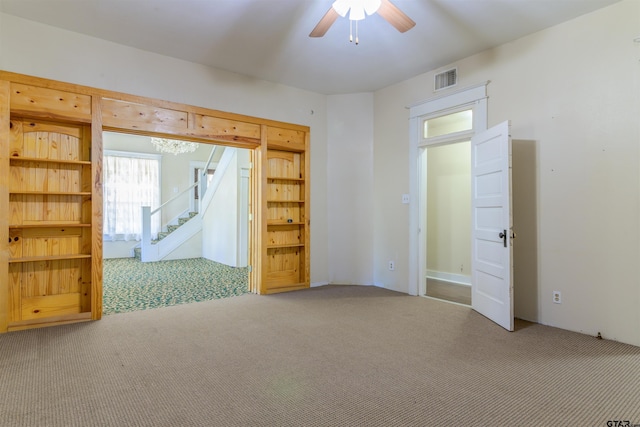 unfurnished room with carpet flooring and ceiling fan