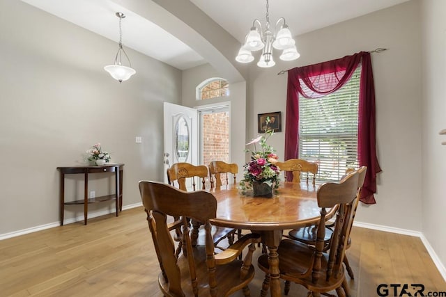 9190 Teal Flight Way, Tyler, TX 75703 - dining room featuring arched walkways, light wood-style flooring, a chandelier, and baseboards
