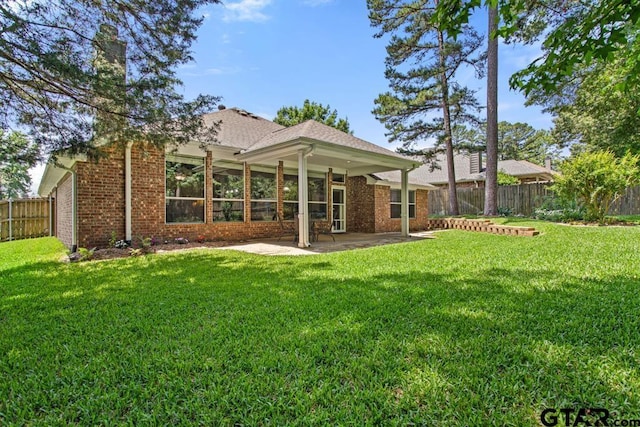 9190 Teal Flight Way, Tyler, TX 75703 - rear view of property with brick siding, a patio area, and a chimney