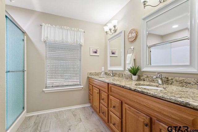 9190 Teal Flight Way, Tyler, TX 75703 - bathroom with double vanity, a shower with shower door, baseboards, and marble look tiles