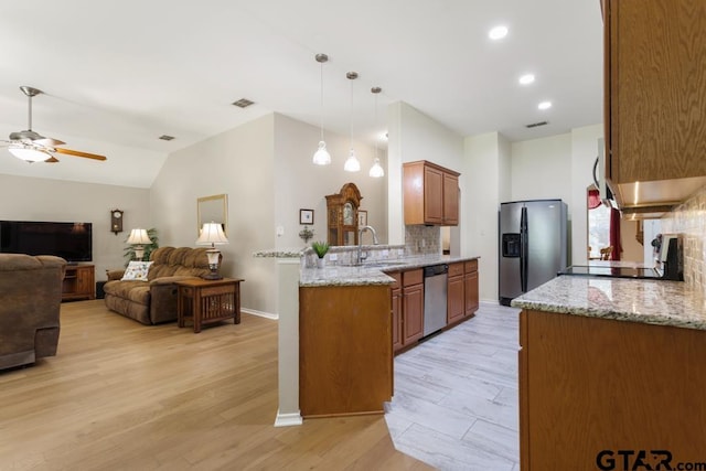 9190 Teal Flight Way, Tyler, TX 75703 - kitchen featuring stainless steel appliances, a sink, backsplash, ceiling fan, and light stone counters
