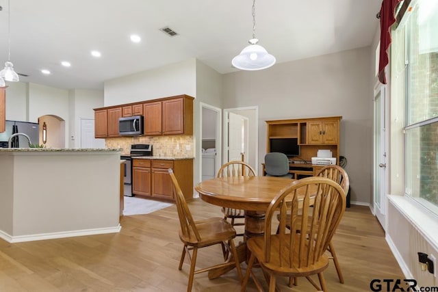 9190 Teal Flight Way, Tyler, TX 75703 - dining space with light wood finished floors, washer / dryer, recessed lighting, and baseboards