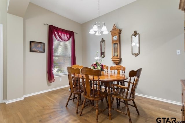 9190 Teal Flight Way, Tyler, TX 75703 - dining area with a chandelier, wood finished floors, and baseboards