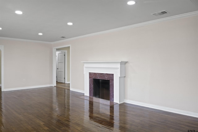 unfurnished living room featuring ornamental molding, dark wood-type flooring, and a fireplace