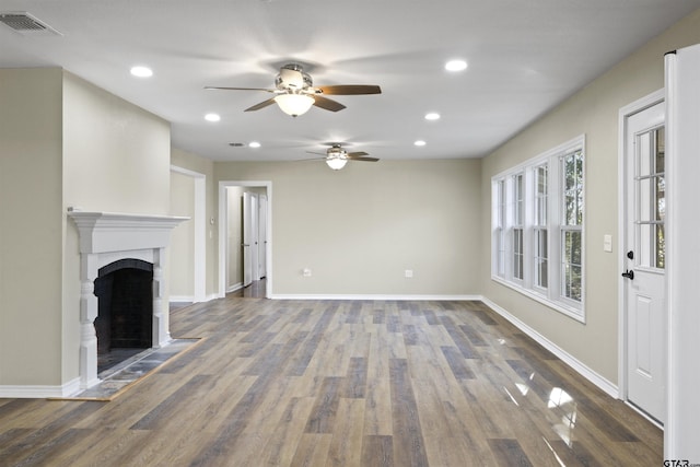 unfurnished living room featuring a fireplace and dark wood-type flooring