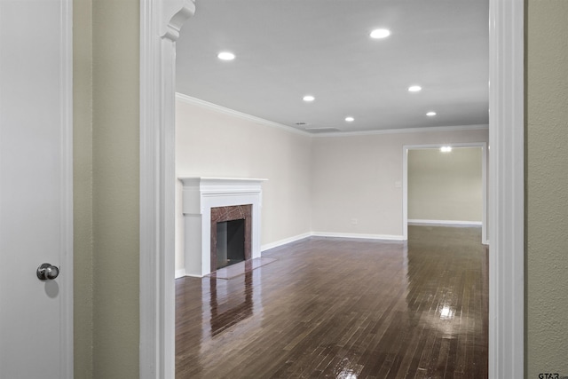 unfurnished living room with crown molding, a fireplace, and dark hardwood / wood-style floors