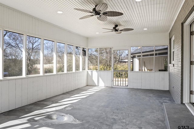 unfurnished sunroom featuring ceiling fan