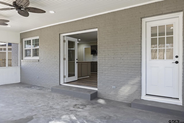 property entrance featuring a patio area and ceiling fan