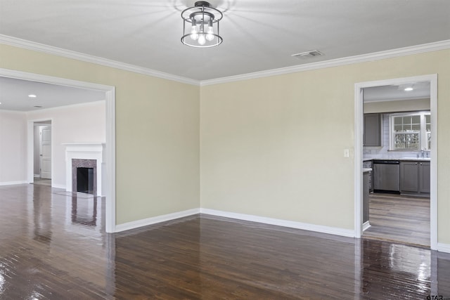 interior space with sink, a high end fireplace, dark wood-type flooring, and ornamental molding