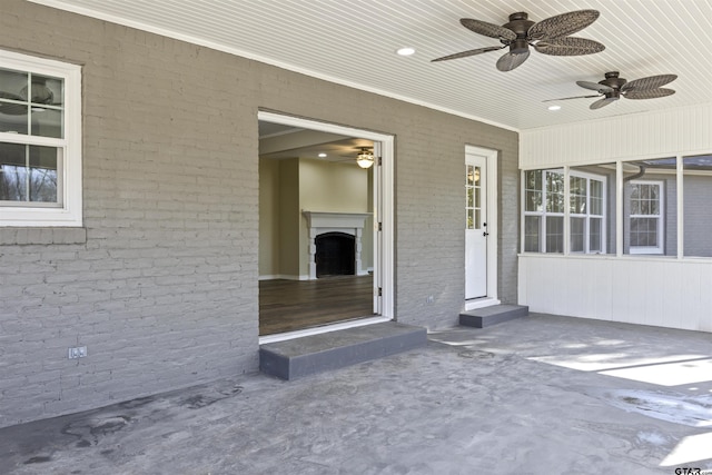 property entrance featuring ceiling fan and a patio