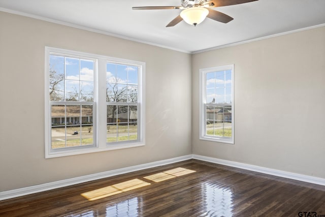 spare room featuring crown molding, dark wood-type flooring, and ceiling fan