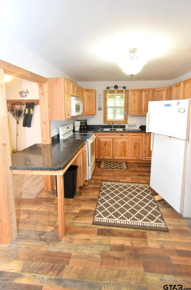 1611 County Road 1858, Yantis, TX 75497 - kitchen featuring white appliances, wood finished floors, and light brown cabinets