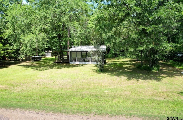 1611 County Road 1858, Yantis, TX 75497 - view of green lawn with an outdoor structure