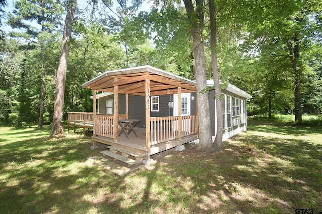 1611 County Road 1858, Yantis, TX 75497 - view of home's exterior with a lawn and a wooden deck