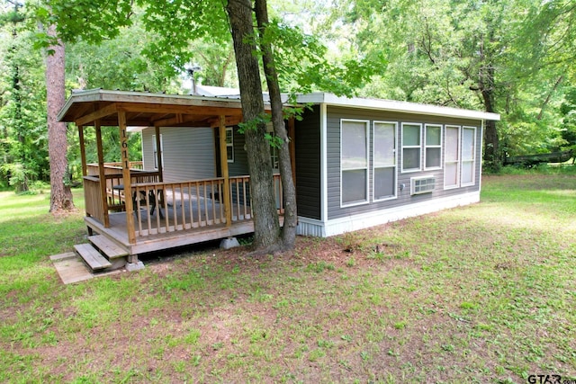 1611 County Road 1858, Yantis, TX 75497 - rear view of house with a wooden deck and a lawn