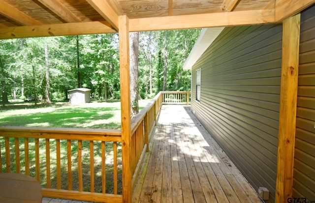 1611 County Road 1858, Yantis, TX 75497 - wooden deck featuring a yard, a storage shed, and view of scattered trees