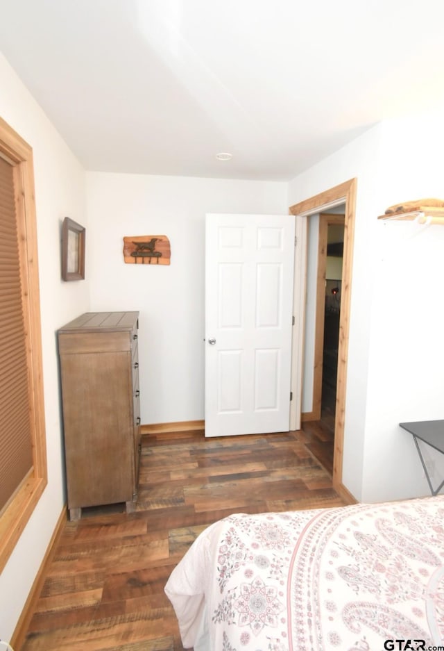 1611 County Road 1858, Yantis, TX 75497 - bedroom with dark wood-style flooring and baseboards