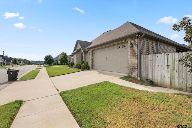 view of side of property with a garage and a yard