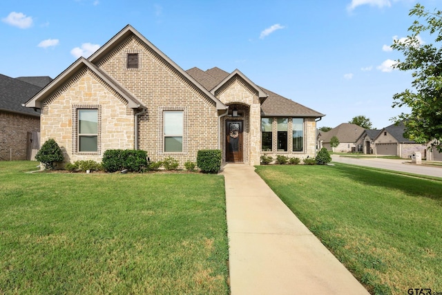 french country style house with a front yard