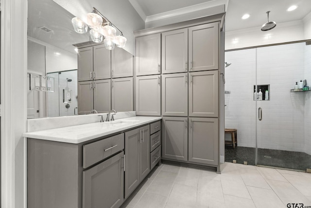 bathroom featuring a shower with shower door, tile patterned floors, and vanity