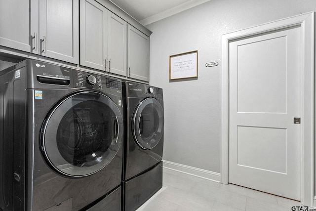 clothes washing area featuring cabinets, separate washer and dryer, and crown molding