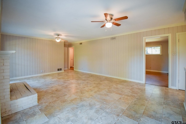 unfurnished living room featuring a brick fireplace, ceiling fan, and ornamental molding