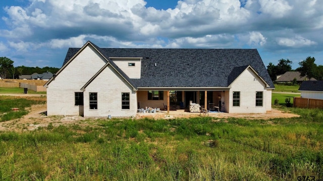 back of house featuring a patio and brick siding