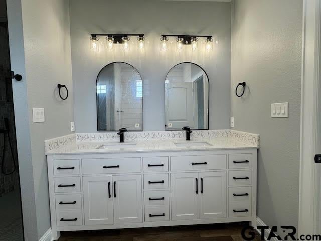14909 Turtle Creek Ranch Rd, Flint, TX 75762 - bathroom featuring double vanity and wood finished floors