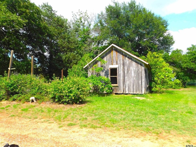 view of outbuilding with a yard