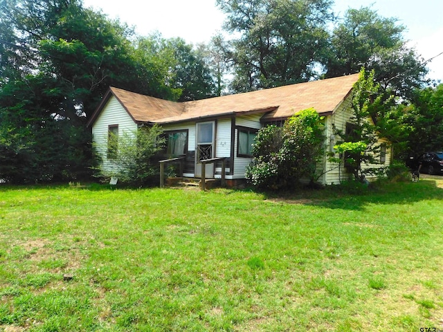 rear view of house with a yard