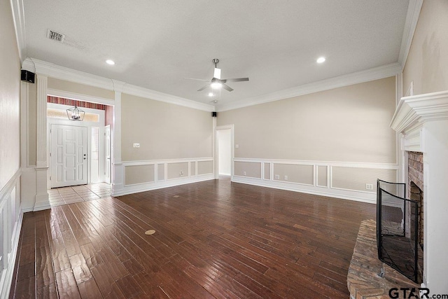 19173 Greenleaf Dr, Flint, TX 75762 - unfurnished living room featuring ceiling fan, hardwood / wood-style floors, a decorative wall, a wainscoted wall, and a brick fireplace