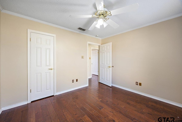 unfurnished bedroom with a textured ceiling, ceiling fan, crown molding, and dark hardwood / wood-style floors