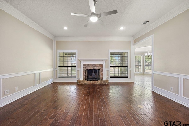 19173 Greenleaf Dr, Flint, TX 75762 - unfurnished living room with a ceiling fan, plenty of natural light, a fireplace, dark wood-style flooring, and crown molding