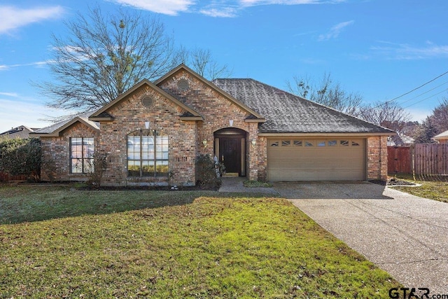 ranch-style home with a front lawn and a garage