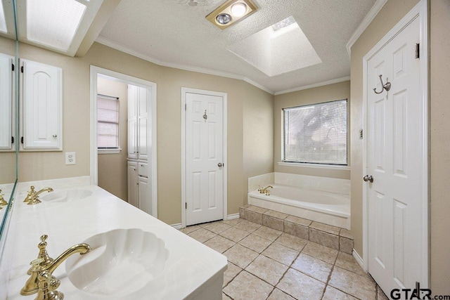 19173 Greenleaf Dr, Flint, TX 75762 - bathroom featuring a bath, double vanity, crown molding, tile patterned flooring, and a textured ceiling