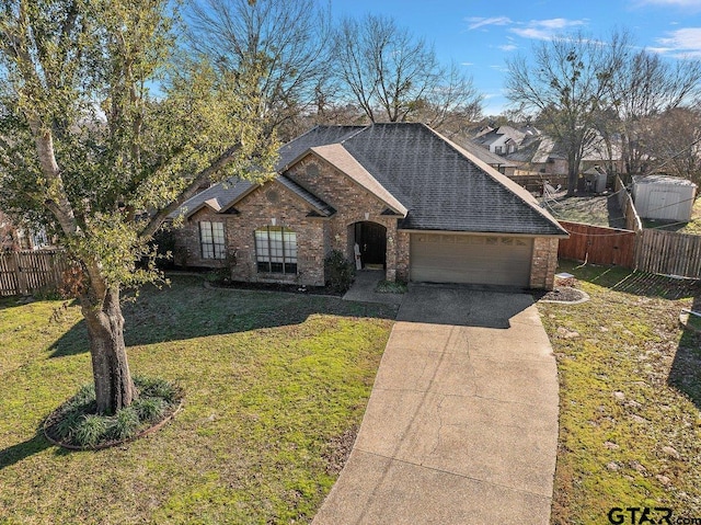 view of front of house with a front yard and a garage