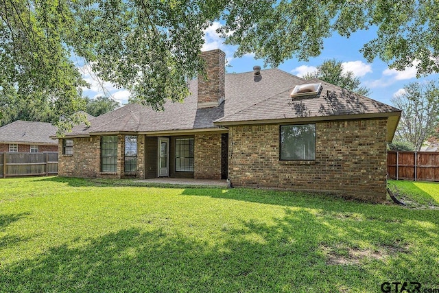 19173 Greenleaf Dr, Flint, TX 75762 - rear view of house featuring a chimney, brick siding, and roof with shingles