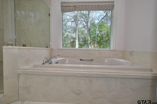 bathroom with tiled tub