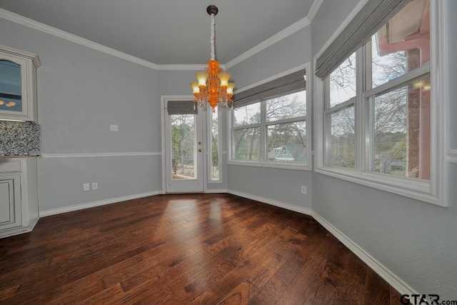 unfurnished dining area with a chandelier, crown molding, and dark wood-type flooring