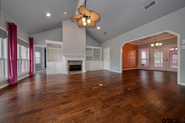 unfurnished living room featuring ceiling fan with notable chandelier, high vaulted ceiling, a fireplace, ornamental molding, and dark hardwood / wood-style flooring