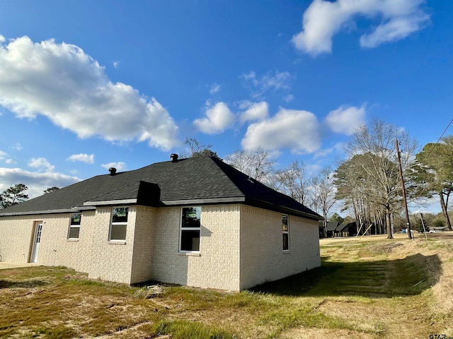 view of property exterior with a yard