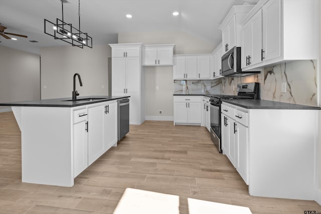 16509 Crossing Cir, Lindale, TX 75771 - kitchen with appliances with stainless steel finishes, dark countertops, recessed lighting, ceiling fan, and white cabinetry