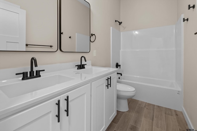 16509 Crossing Cir, Lindale, TX 75771 - full bathroom with double vanity,  shower combination, and wood finished floors