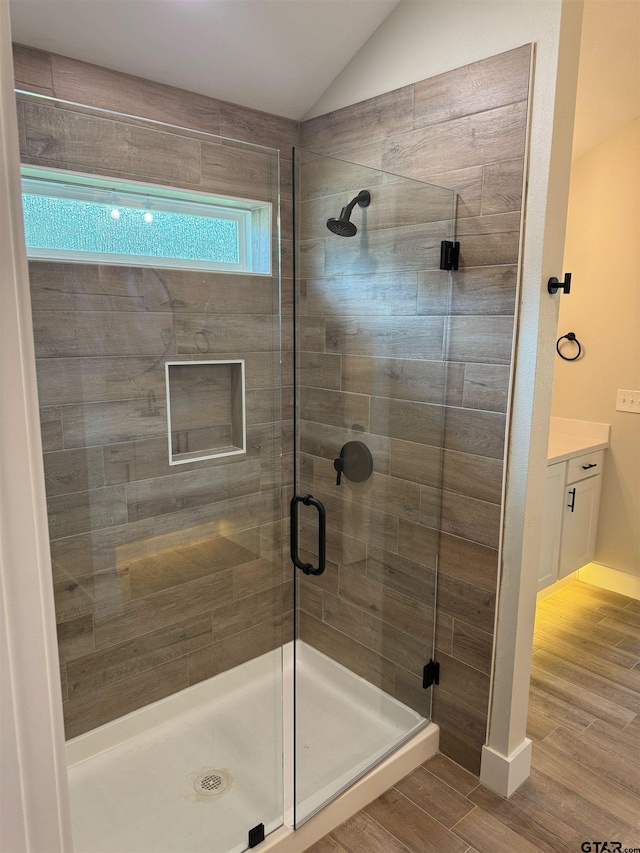 16509 Crossing Cir, Lindale, TX 75771 - bathroom featuring a stall shower, wood finished floors, lofted ceiling, and vanity
