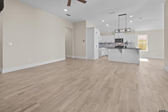 16509 Crossing Cir, Lindale, TX 75771 - unfurnished living room featuring a ceiling fan, light wood-type flooring, and recessed lighting