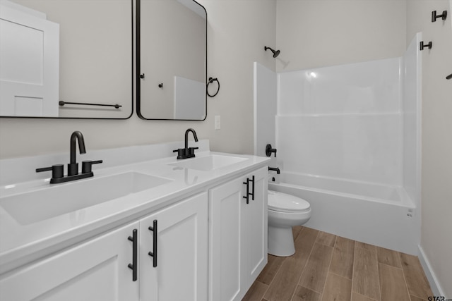16509 Crossing Cir, Lindale, TX 75771 - bathroom featuring double vanity, shower / bathtub combination, and wood finished floors