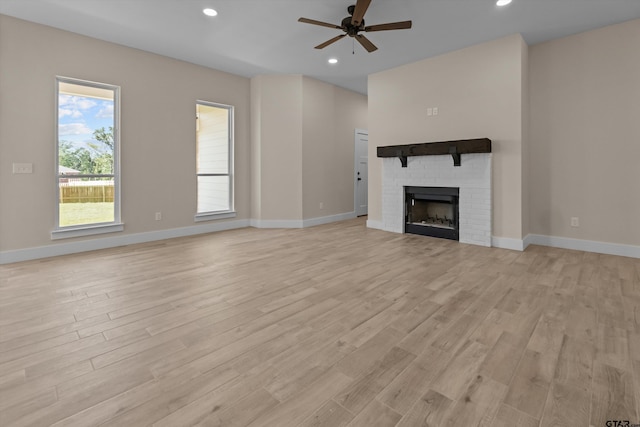 16509 Crossing Cir, Lindale, TX 75771 - unfurnished living room with ceiling fan, light wood finished floors, recessed lighting, and a brick fireplace